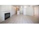 Open-concept living area with fireplace, tile flooring, and a partial view into the kitchen at 7155 S Durango Dr # 205, Las Vegas, NV 89113