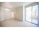 Bright and airy living room with tile flooring, access to the balcony through sliding glass door at 7155 S Durango Dr # 205, Las Vegas, NV 89113