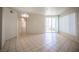 Spacious living area with tile flooring and sliding door to balcony offering natural light at 7155 S Durango Dr # 205, Las Vegas, NV 89113