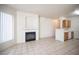 Cozy living room with fireplace, a large window, and tile flooring with an open kitchen view at 7155 S Durango Dr # 205, Las Vegas, NV 89113