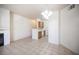 Comfortable living space featuring tile flooring, a fireplace, and an adjacent kitchen area at 7155 S Durango Dr # 205, Las Vegas, NV 89113