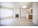 Inviting living room with fireplace, large window, and tile floors with an open kitchen view at 7155 S Durango Dr # 205, Las Vegas, NV 89113