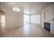 Spacious living room with tile floors, fireplace, balcony access, and chandelier at 7155 S Durango Dr # 205, Las Vegas, NV 89113