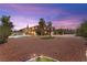 Expansive backyard featuring desert landscaping, mature palm trees, and ample space for outdoor activities and potential customization at 7794 River Mist Ct, Las Vegas, NV 89113