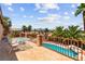 A balcony overlooking the backyard and pool, furnished with a small table and chairs at 7794 River Mist Ct, Las Vegas, NV 89113