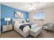 Inviting bedroom featuring a large window, bedside tables with lamps and wall art at 7794 River Mist Ct, Las Vegas, NV 89113