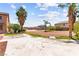 Long driveway leads to a large desert-landscaped backyard, lush landscaping, and shed at 7794 River Mist Ct, Las Vegas, NV 89113