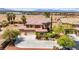 Stunning home featuring a grand entrance, mature palm trees, and a spacious driveway leading to a three-car garage at 7794 River Mist Ct, Las Vegas, NV 89113