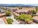 Beautiful two-story home with a manicured front yard, mature trees, and an elegant facade, showcasing curb appeal at 7794 River Mist Ct, Las Vegas, NV 89113