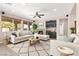 Inviting living room featuring a fireplace, large windows with outdoor views, and neutral tones at 7794 River Mist Ct, Las Vegas, NV 89113
