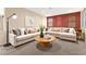 Comfortable living room with a large sectional sofa, round coffee table, and contemporary decor at 7794 River Mist Ct, Las Vegas, NV 89113