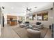 Open-concept living room and kitchen, featuring comfortable seating, large windows, and modern finishes at 7794 River Mist Ct, Las Vegas, NV 89113