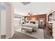Spacious main bedroom with a seating area, balcony access, and an ensuite bathroom at 7794 River Mist Ct, Las Vegas, NV 89113