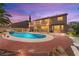 Inviting backyard with a sparkling pool and lush landscaping perfect for outdoor entertaining and relaxing evenings at 7794 River Mist Ct, Las Vegas, NV 89113