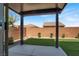 Cozy backyard features a covered patio, small grass area, and brick privacy wall at 7814 Granite City Ct, Las Vegas, NV 89166