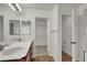 Bright bathroom featuring double sinks, vanity, and entry into closet at 7814 Granite City Ct, Las Vegas, NV 89166