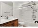 Bathroom with wood vanity, sink, toilet, and shower/tub combo at 7814 Granite City Ct, Las Vegas, NV 89166