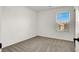 Bright bedroom with carpet, a large window with blinds, and ample natural light at 7814 Granite City Ct, Las Vegas, NV 89166