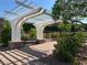 Picturesque community arbor over a bench on a brick-paved walkway surrounded by lush landscaping at 7814 Granite City Ct, Las Vegas, NV 89166