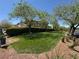 Picturesque green space with manicured lawn and mature trees in the Providence community at 7814 Granite City Ct, Las Vegas, NV 89166