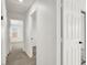 Bright hallway with neutral carpet and white walls leads to other rooms in the home at 7814 Granite City Ct, Las Vegas, NV 89166