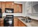 The kitchen features a double stainless steel sink, granite counters, and a black range at 7814 Granite City Ct, Las Vegas, NV 89166