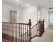 View of landing with wood railing and plush neutral carpeting at 7814 Granite City Ct, Las Vegas, NV 89166