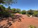 Scenic walking trail with mature trees, drought-tolerant landscaping, and inviting natural beauty at 7814 Granite City Ct, Las Vegas, NV 89166
