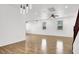 Spacious living room with wood floors, ceiling fan, recessed lights, and a staircase at 7814 Granite City Ct, Las Vegas, NV 89166
