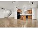 Open-concept living room featuring hardwood floors, stairway, and a kitchen with an island at 7814 Granite City Ct, Las Vegas, NV 89166