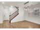 Spacious living area featuring wood floors, staircase, and modern light fixtures at 7814 Granite City Ct, Las Vegas, NV 89166