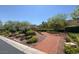 Charming community walking path through landscaped gardens with blooming flowers and benches at 7814 Granite City Ct, Las Vegas, NV 89166