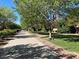 Scenic walking path lined with mature trees and manicured landscaping, perfect for a stroll at 7814 Granite City Ct, Las Vegas, NV 89166
