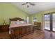 Bright bedroom featuring a large wooden bed frame, hardwood floors, and access to the outdoors through French doors at 800 Antonio Dr, Las Vegas, NV 89107