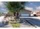 Inviting single-story home with a desert-style front yard and a wide driveway leading to a garage at 800 Antonio Dr, Las Vegas, NV 89107