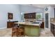 Bright kitchen featuring a central island with seating, granite counters, and wooden cabinetry at 800 Antonio Dr, Las Vegas, NV 89107