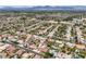 Beautiful neighborhood aerial view featuring lush landscaping, many pools, and mountain views in the distance at 8032 Audubon Canyon St, Las Vegas, NV 89131