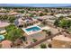 Expansive backyard featuring a sparkling pool, patio area, lush landscaping, and mountain views at 8032 Audubon Canyon St, Las Vegas, NV 89131