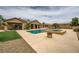 Backyard oasis featuring a pool, spa, patio, and desert landscaping at 8032 Audubon Canyon St, Las Vegas, NV 89131