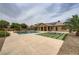 Expansive backyard with a pool, fire pit, and ample patio space for outdoor enjoyment at 8032 Audubon Canyon St, Las Vegas, NV 89131
