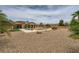Wide angle view of a backyard with a pool, desert landscaping, and gravel ground cover at 8032 Audubon Canyon St, Las Vegas, NV 89131