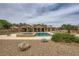 Backyard featuring a pool, desert landscaping, and gravel ground cover at 8032 Audubon Canyon St, Las Vegas, NV 89131