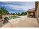 Spacious backyard featuring a pool, fire pit, and ample room for entertaining and relaxation at 8032 Audubon Canyon St, Las Vegas, NV 89131