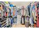 Walk-in closet featuring custom shelves, multiple hanging areas, and shoe storage at 8032 Audubon Canyon St, Las Vegas, NV 89131
