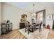Elegant dining room with a modern chandelier, sophisticated furniture, and open access to other rooms at 8032 Audubon Canyon St, Las Vegas, NV 89131