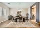 Elegant dining room with wood-look flooring and sophisticated decor, perfect for gatherings at 8032 Audubon Canyon St, Las Vegas, NV 89131