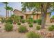 Well-landscaped front yard with desert plants and mature trees surrounding a single-story home at 8032 Audubon Canyon St, Las Vegas, NV 89131
