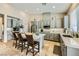 Well-lit kitchen featuring an island with seating, gray cabinetry, and stainless steel appliances at 8032 Audubon Canyon St, Las Vegas, NV 89131