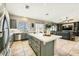 Open kitchen with gray cabinets, center island, and seamless transition to the living area at 8032 Audubon Canyon St, Las Vegas, NV 89131