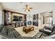 Comfortable living room with a fireplace, custom entertainment center, and seamless flow to other areas at 8032 Audubon Canyon St, Las Vegas, NV 89131